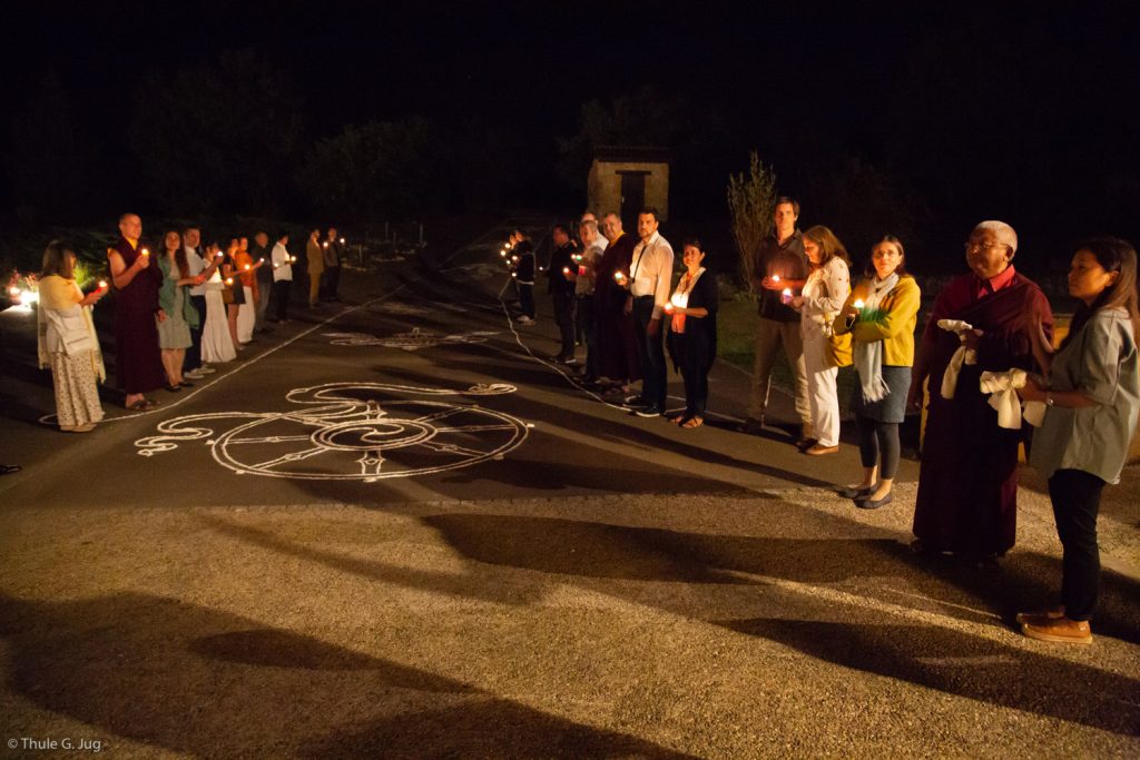 Students prepare for the arrival of Thaye Dorje, His Holiness the 17th Gyalwa Karmapa, at Dhagpo Kagyu Ling. The road is marked with auspicious signs in anticipation of Karmapa's arrival.