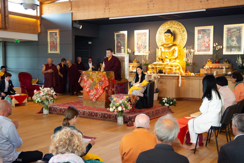 Students pray with Thaye Dorje, His Holiness the 17th Gyalwa Karmapa, Sangyumla Rinchen Yangzom, and their newborn son Thugsey at Dhagpo Kagyu Ling