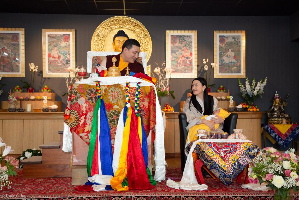 Thaye Dorje, His Holiness the 17th Gyalwa Karmapa, shares a smile with Sangyumla Rinchen Yangzom and their newborn son Thugsey during a special reception at Dhagpo Kagyu Ling