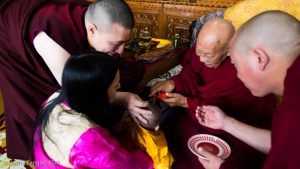 The moment when His Eminence Luding Khenchen Rinpoche, the 75th head of the Ngor tradition of the Sakya school of Tibetan Buddhism, cuts the hair of Thugsey, symbolizing his taking refuge in the Three Jewels: the Buddha, the dharma and the sangha